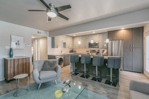 open-concept living room and kitchen in Dallas apartment at Reserve on Abrams