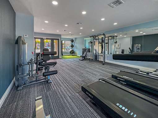 Fitness center with treadmills and weights – Borders Apartments Brownsville TX