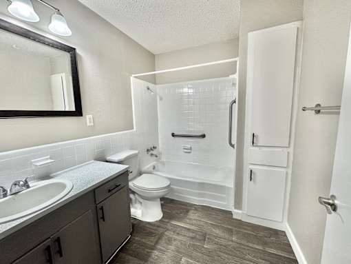 Bathroom with shower, toilet, and sink at Greenbriar Place 55+ Senior Apartments in Corpus Christi.