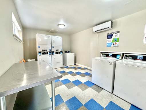 Laundry facility with washers and dryers at Greenbriar Place Apartments.