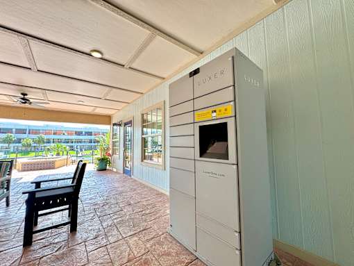 A patio area with a table and chairs and a LUXER branded oven.