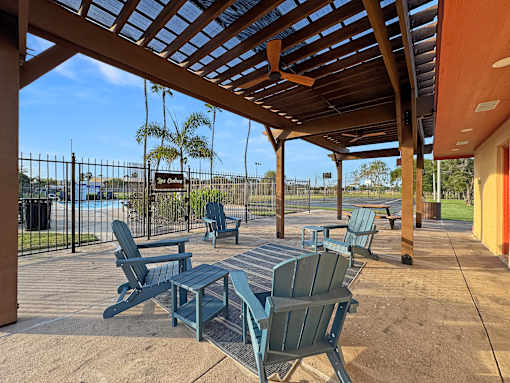A patio with a table and chairs under a roof.