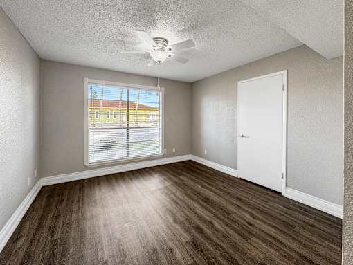 One Bedroom with vinyl flooring and ceiling fan – Borders Apartments Brownsville TX