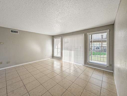 Tile floor living room with sliding patio door – Borders Apartments Brownsville TX