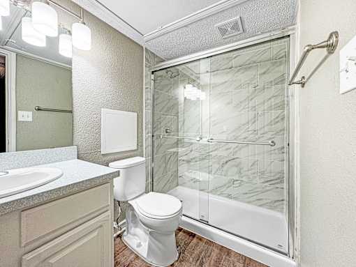 Bathroom with modern vanity and bright mirror lighting at Verano Oaks
