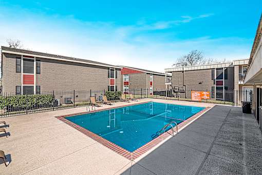 Resort-style swimming pool with lounge seating at Sage Creek Apartment
