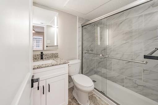 Contemporary bathroom with large mirror and modern lighting