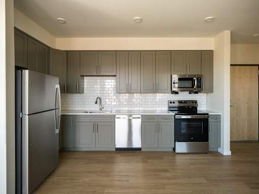 Apartment kitchen with refrigerator, microwave and stove