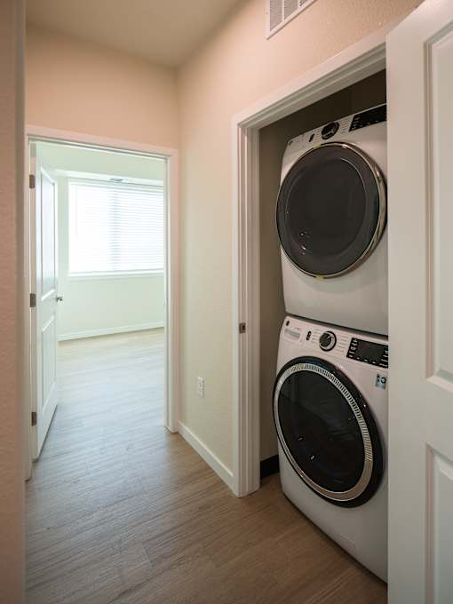 A white washing machine is in a doorway.