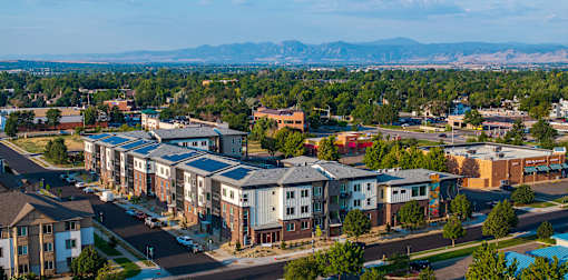 A bird's eye view of a residential area with houses and apartment buildings.