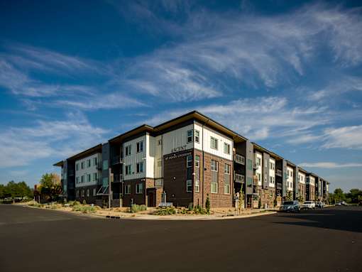 Apartment complex with a car parked in front.