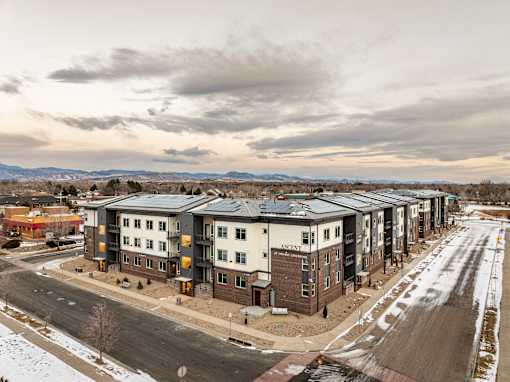 Apartment complex with a road in front of it.