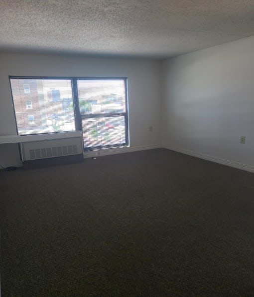 an empty room with two windows