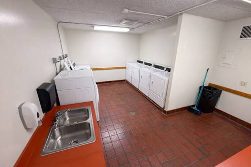 A kitchen with a sink and a dishwasher.