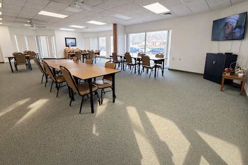A conference room with a long table and chairs.
