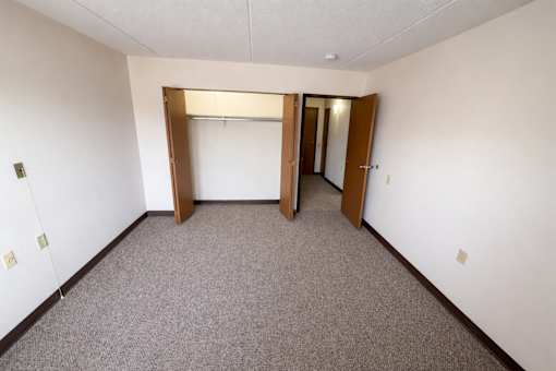 A room with a carpeted floor and white walls.