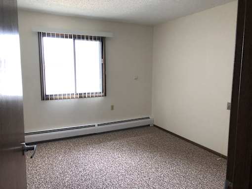 A room with a window and a door.