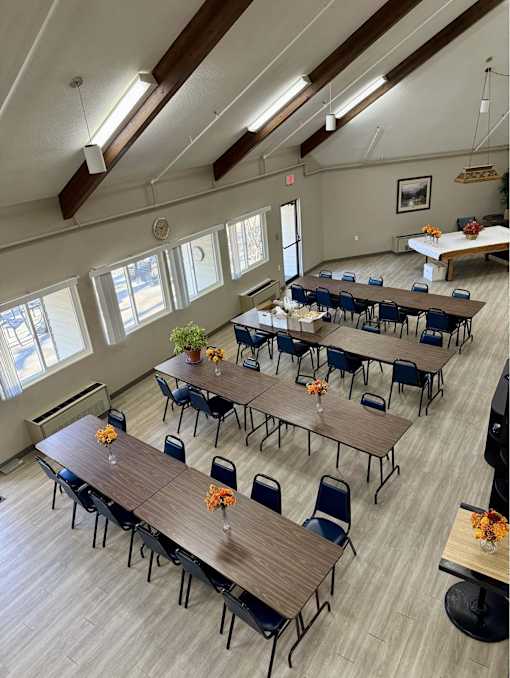 A room with tables and chairs set up for an event.