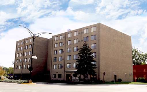 A tall building with a tree in front of it.