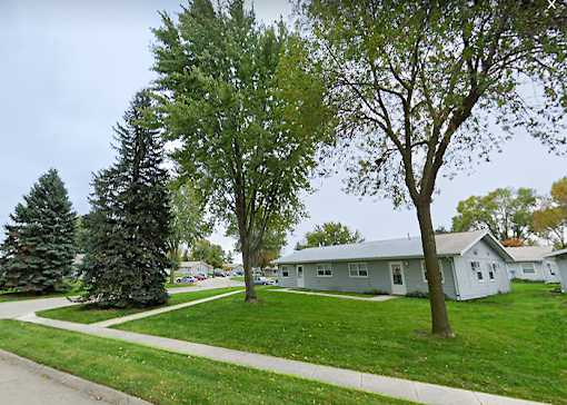 A tree in front of a house.