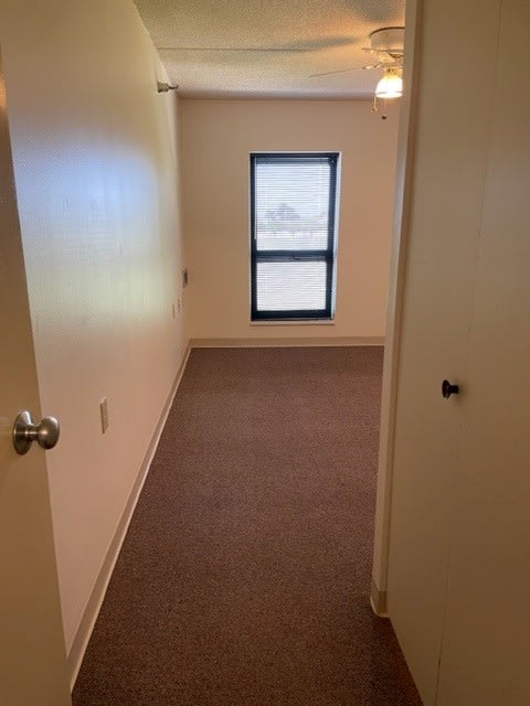 an empty room with a window and a door