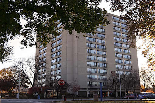 A tall building with a stop sign in front of it.