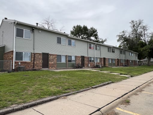 an image of an apartment building with a sidewalk