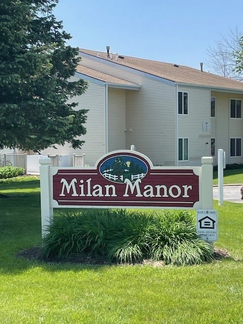 a sign in front of a house