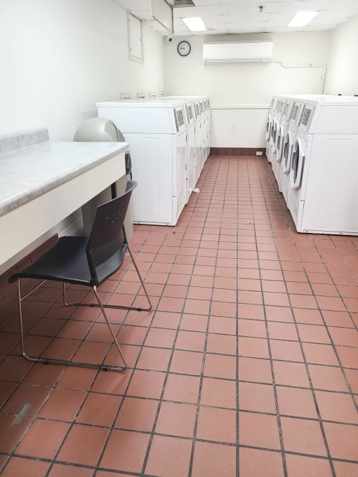 a laundromat with a table and chairs and washers and dryers