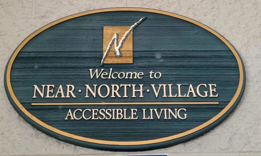 a sign that reads welcome to near north village