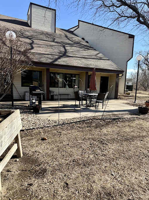 A house with a patio and a table set up outside.