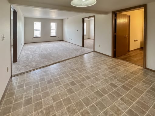 the living room and dining room of a new home with a large empty room