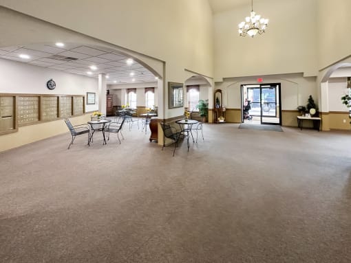 a large room with tables and chairs in the center of it