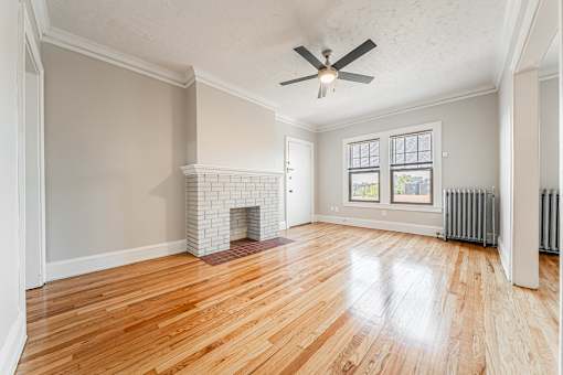 Living room with a fireplace and wood flooring at Integrity Gold Coast Apartments, Cleveland, Ohio