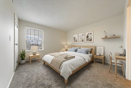 A bedroom with a bed, desk, chair, and window at Hunt Club Apartments, Ohio, 44321