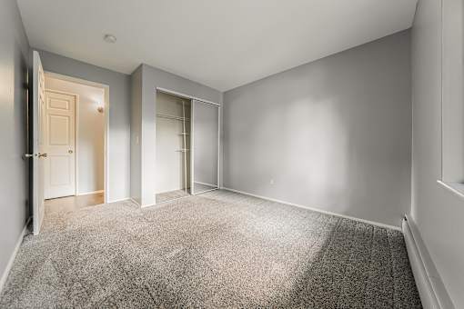 A room with a carpeted floor and two doors. at Integrity Berea Apartments, Berea, Ohio