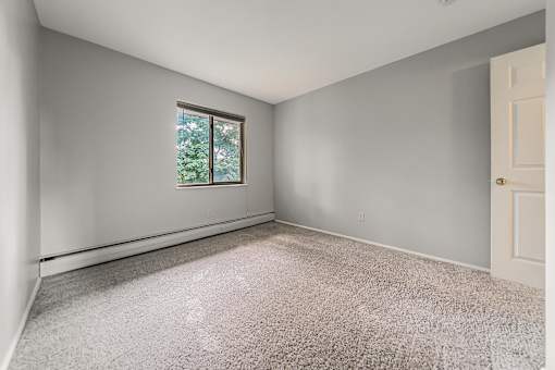 A room with a window and carpeted floor. at Integrity Berea Apartments, Berea, Ohio