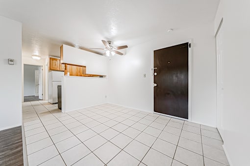 A room with a ceiling fan and a door.