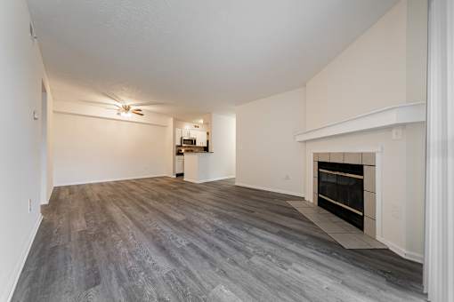 A spacious living room with a fireplace and a ceiling fan at Hunt Club Apartments, Copley, OH, 44321