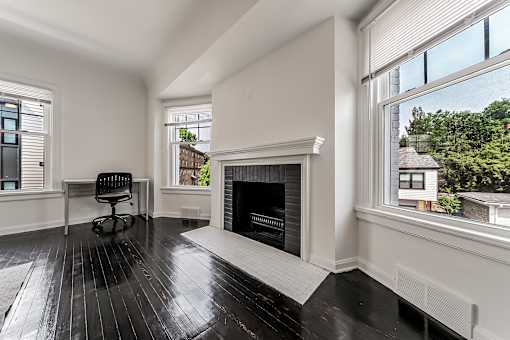 A black and white room with a fireplace and a chair.