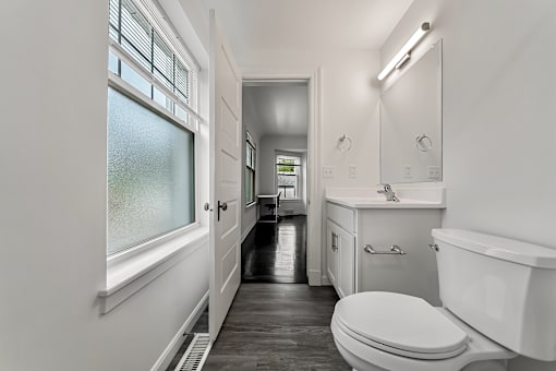 A white bathroom with a toilet, sink, and bathtub.