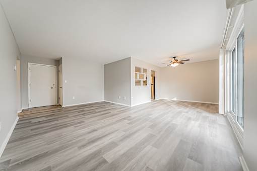 A room with wooden flooring and a ceiling fan.
