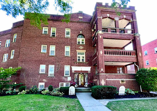 A red brick building with a green tree on top at Integrity Cleveland Heights Apartments, Cleveland Heights, Ohio