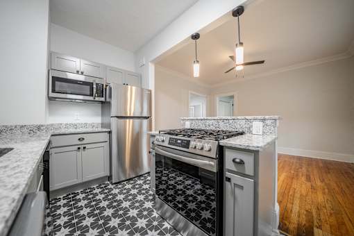A kitchen with a black and white checkered floor.at Integrity Cleveland Heights Apartments,Ohio, 44106