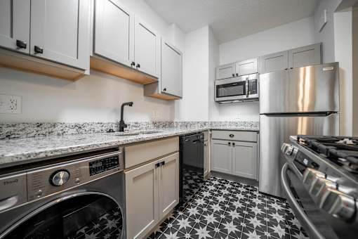 A kitchen with a black and white floor.at Integrity Cleveland Heights Apartments, Cleveland Heights, Ohio