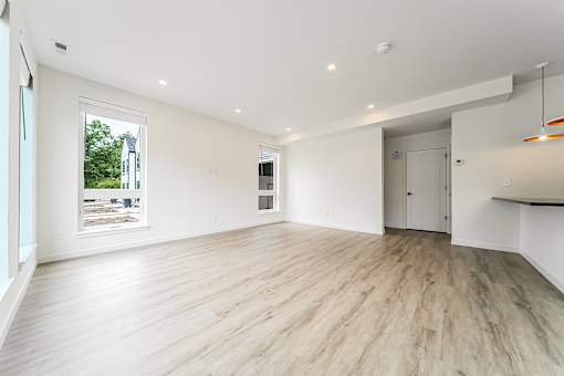 A spacious room with wooden flooring and white walls at Westwood Meadows, Westlake, OH, 44145