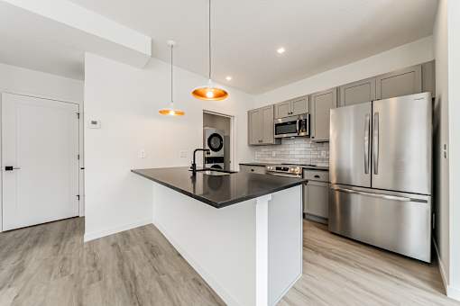 A modern kitchen with stainless steel appliances and a central island at Westwood Meadows, Westlake, OH, 44145