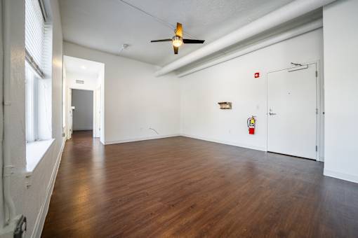 A room with wooden floors and white walls.