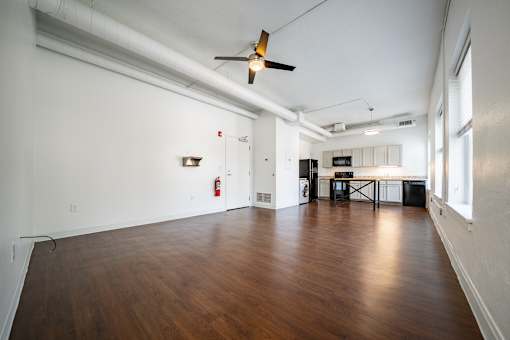 A room with wooden floors and a ceiling fan.