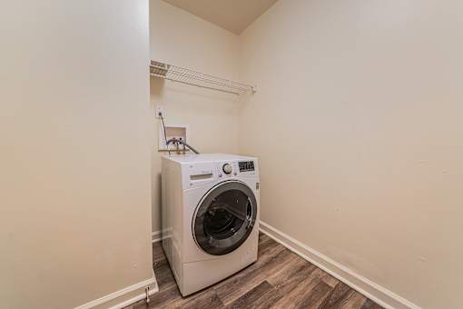A washing machine is sitting in a corner of a room. at Integrity Berea Apartments, Ohio